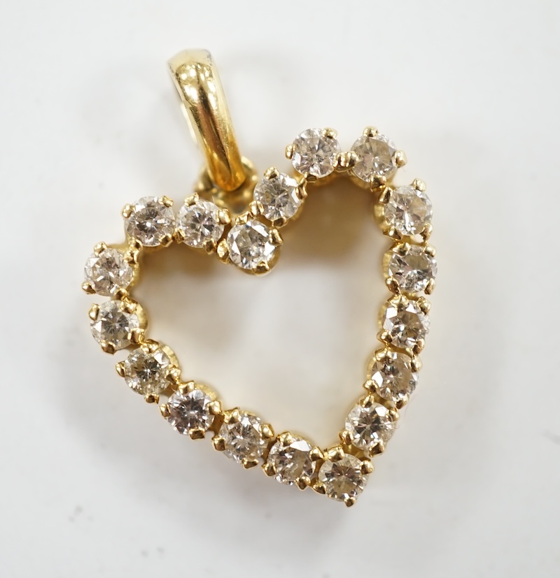 A modern 18k and diamond cluster set open work heart shaped pendant, overall 21mm, gross weight 2.7 grams. Condition - fair to good